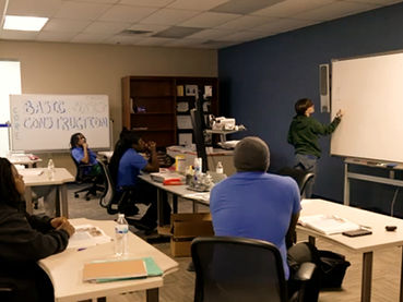 Classroom setting with teacher and student at a whiteboard