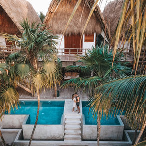 couple standing outside resort from all inclusive honeymoon package