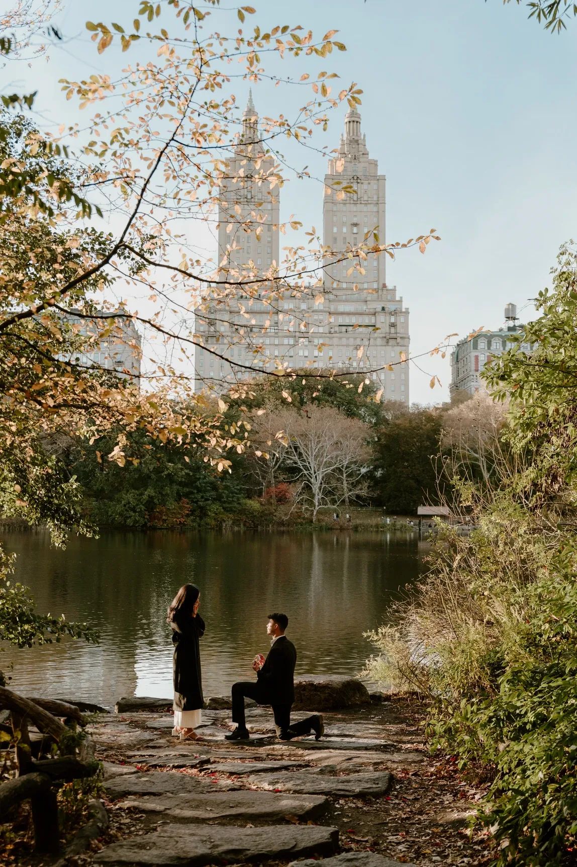 Central Park proposal photographer capturing a surprise proposal by the lake in fall