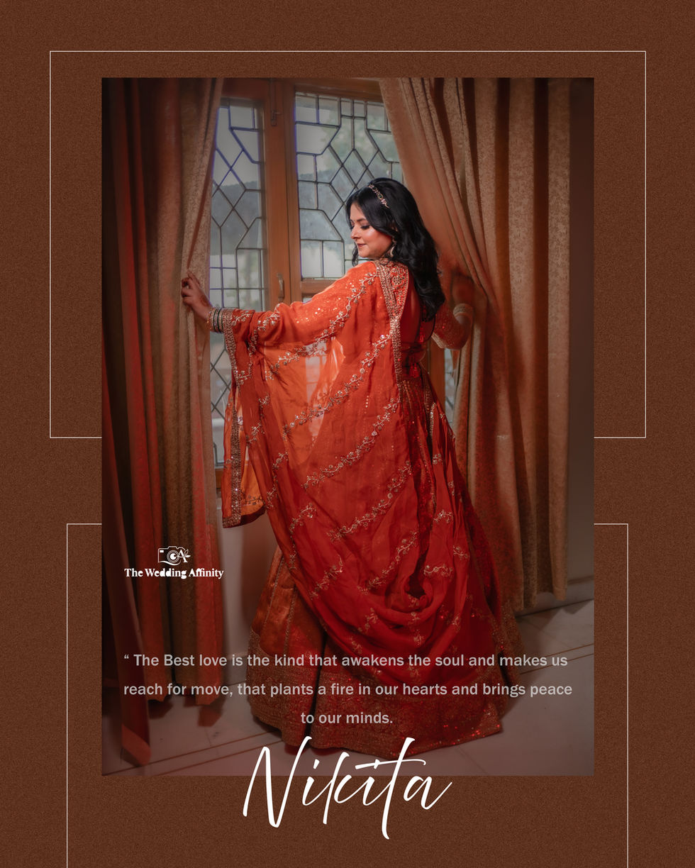 Woman in elegant red dress near window curtains.