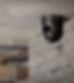 Security camera, monitoring warehouse; mounted on brick. Provides surveillance and security.