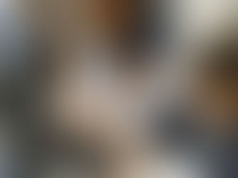 Three young students at a computer, two children typing on a keyboard while a third child looks on