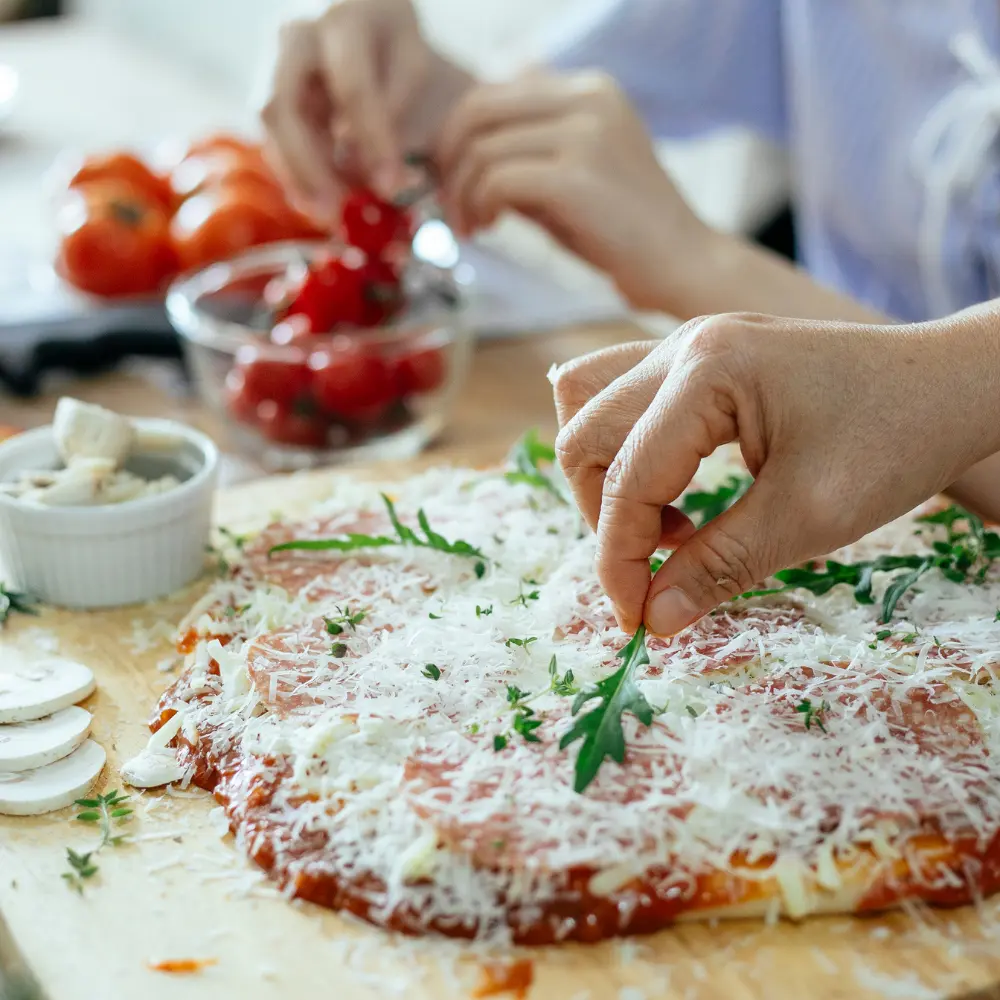 A homemade pizza topped with lashings of parmesan cheese and rocket