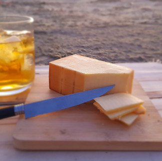 A block of handmade smoked cheese.