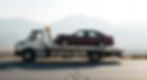 flatbed truck carrying a car