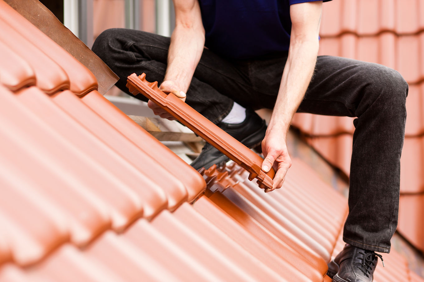 a worker installing a roof tile