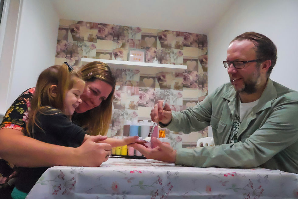 Close-up view of colorful pottery pieces ready for painting