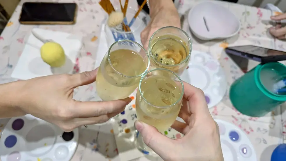 Eye-level view of a beautifully arranged pottery painting station with colorful paints and brushes