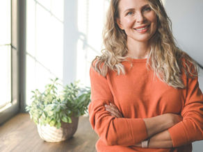 woman with her arms crossed smiling