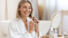 Midlife woman smiling looking in the mirror