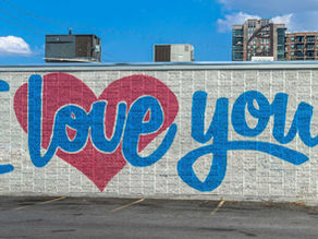 a fence with "I Love You" written on it with blue writing