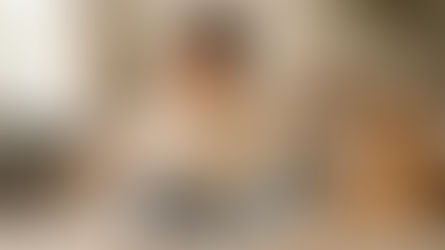 lady sitting on the couch with a dog on one side and a cat on the other side