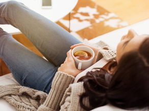 woman drinking hot tea with her feet up