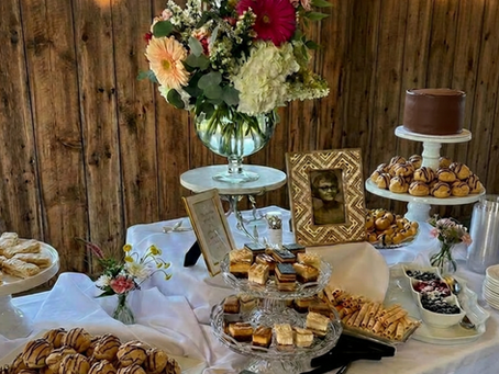 desserts, flowers and photos on a table
