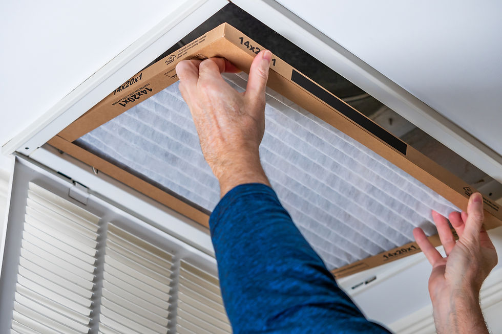 A man changing an AC filter