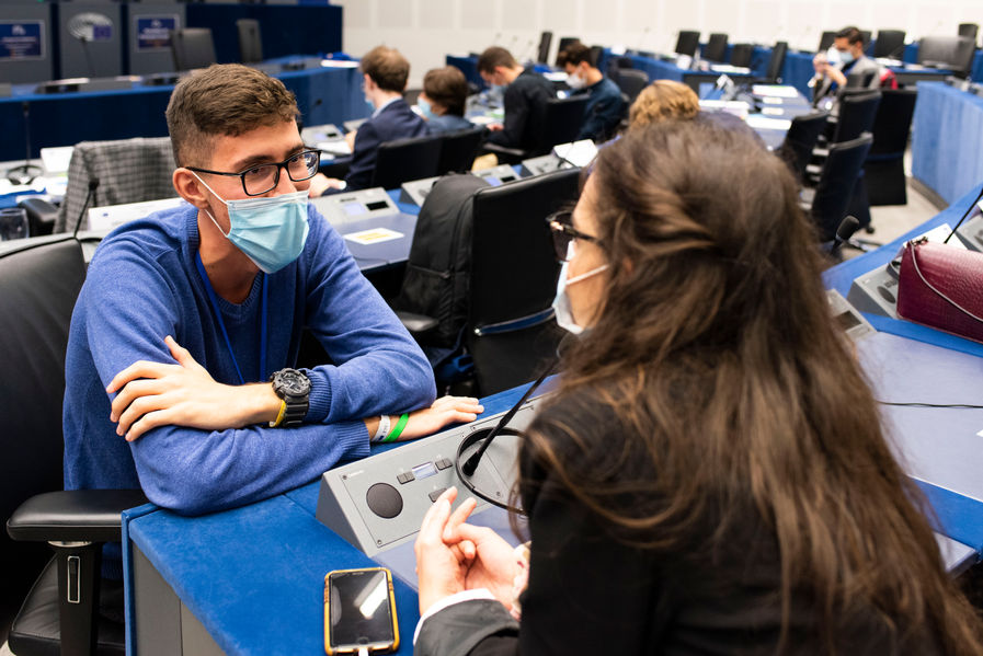 Two young people talking at the European Parliament