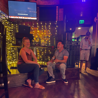 Crowded bar scene at Derwolf Pasadena during Taco Tuesday with guests eating tacos and enjoying karaoke.