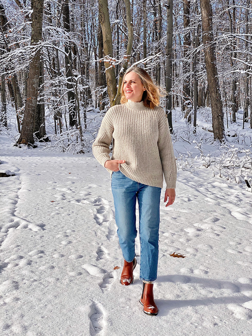woman walking in snow covered forest