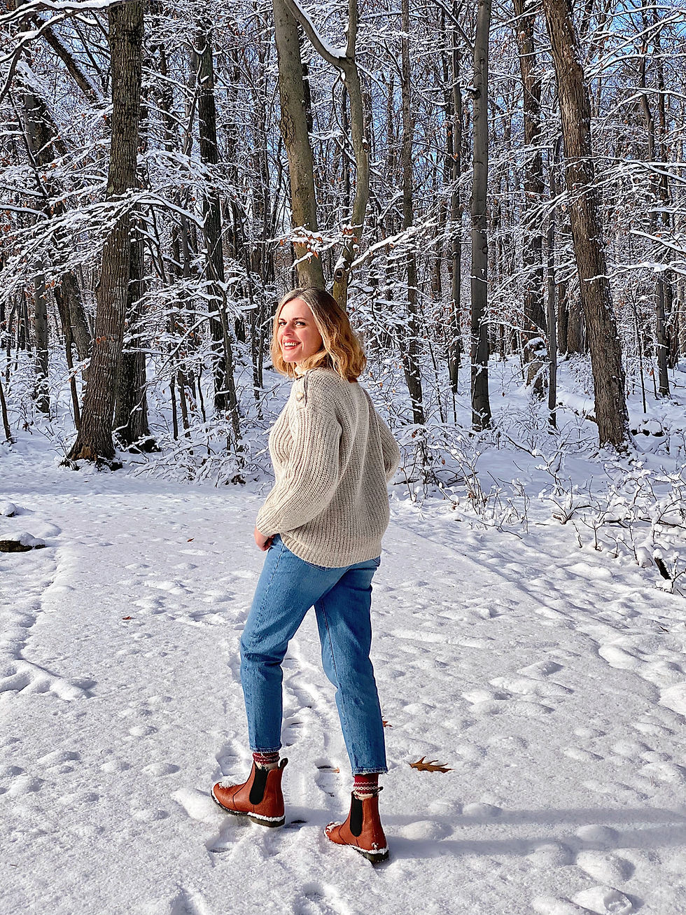 woman walking in snow covered forest