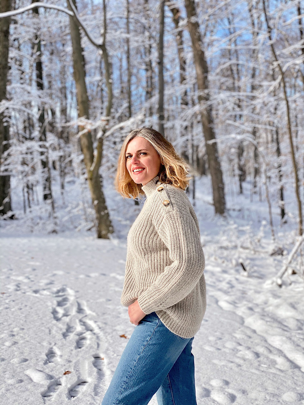 woman walking in snow covered forest