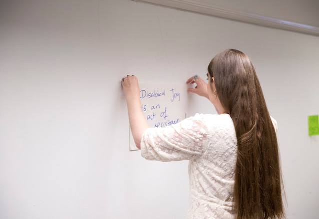 Charlie Fitz sticking a prompt on the wall.