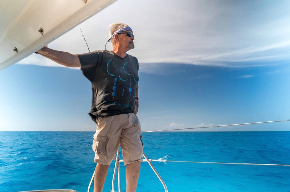 Man on a catamaran Bahamas blue ocean