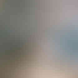 Sage green ensuite with pattern floor tiles and curved shower enclosure