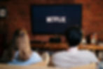 couple on couch watching netflix