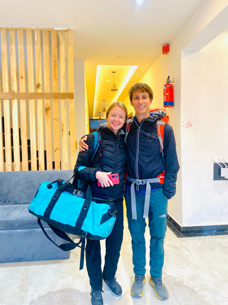 Happy couple at hotel lobby with luggage