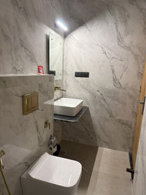 Modern hotel bathroom with marble walls