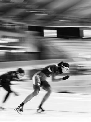 Blur of speed skaters passing by.