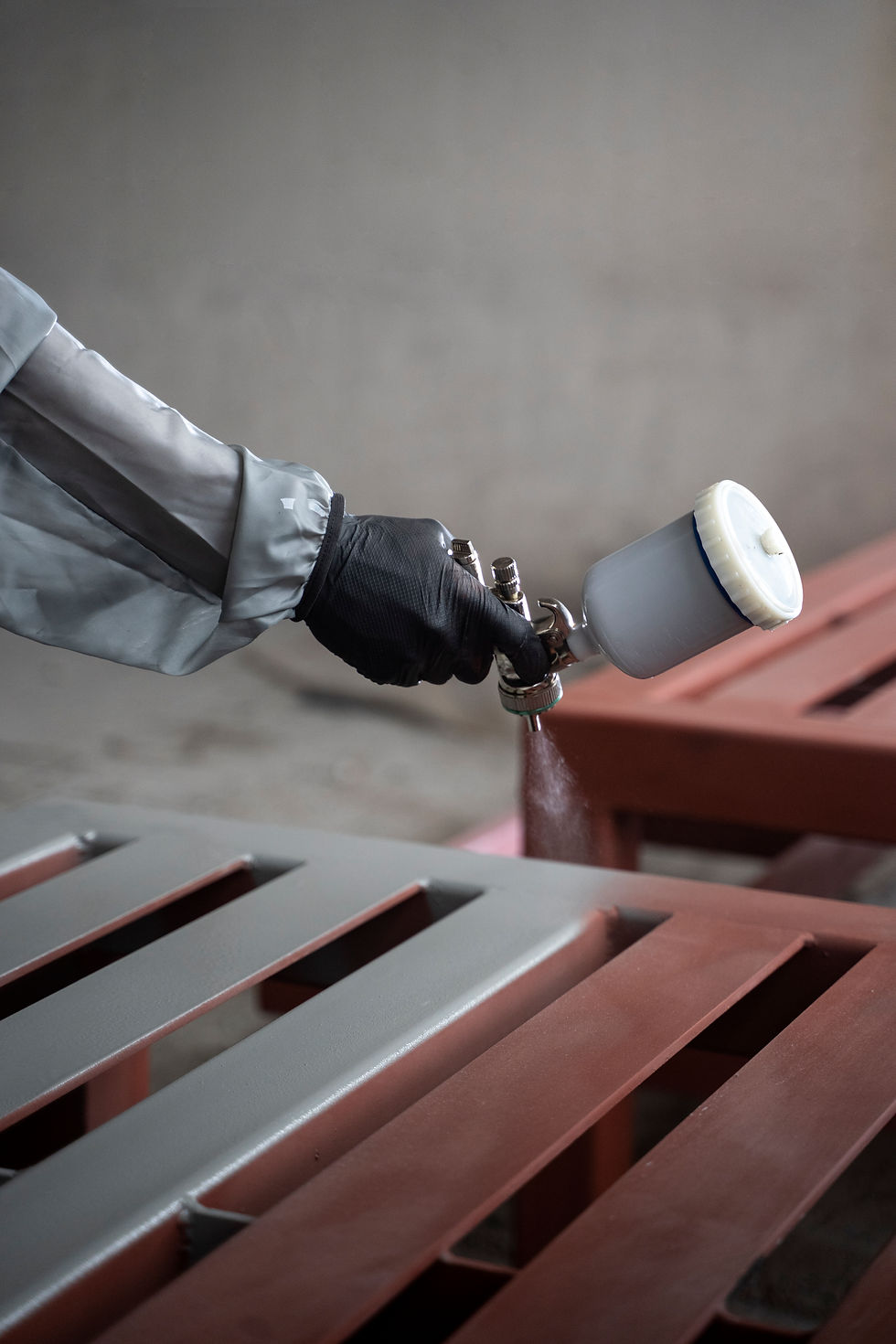 worker-spraying-powder-paint-from-gun-side-view.jpg