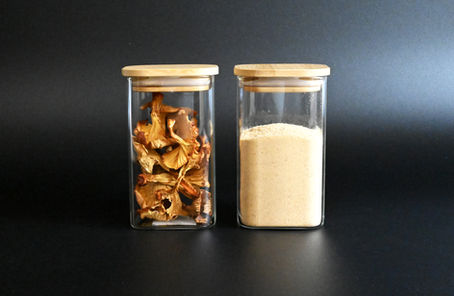 Glass jars with dried medicinal mushrooms and mushroom powder for wholesale distribution