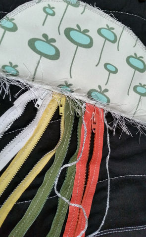 a bunch of different colored zippers are laying on a black surface