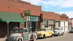 Vintage cars parked along historic Erie Street in the Lowell ghost town neighborhood, a top sight on a Big Jeep Tours itinerary.