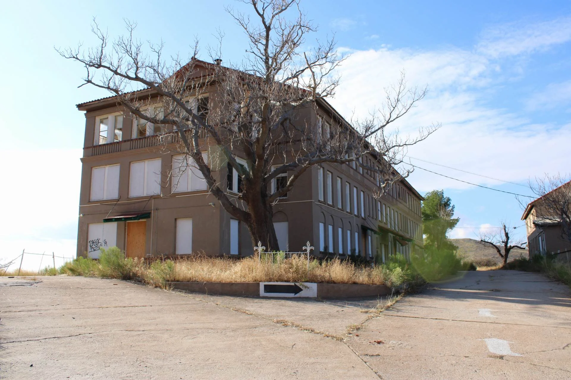 Large abandoned multi-story Calumet and Arizona Hospital building with boarded windows in Bakerville, Bisbee.