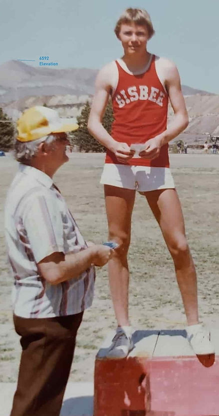 Young Travis Bishop stands proudly on the winner’s podium after winning the high jump at the 1983 Bisbee Invitational. Big Jeep Tours.