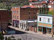 Street view of historic buildings and shops on Brewery Gulch in Old Bisbee, Arizona, a featured highlight on the Bisbee Downtown Tour with Big Jeep Tours.