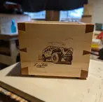 Bright front view of handmade dovetail pine box with engraved Jeep Wrangler.