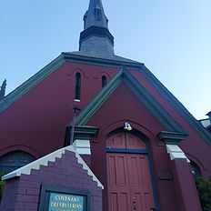 Front view of the Covenant Presbyterian Church in Old Bisbee, Arizona, showing its Gothic Revival doorway, tall steeple, and historic architectural design.