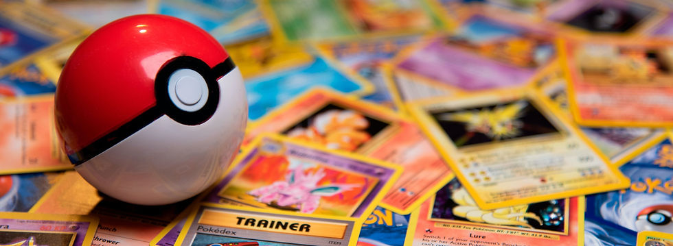 Classic Pokeball Toy on a bunch of Pokemon Cards. Zapdos, Ninetales and a Trainercard visible._edited.jpg