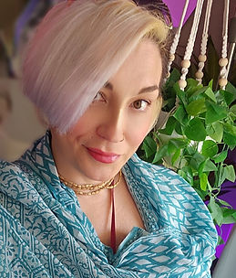 Portrait of a woman with short blonde hair smiling peacefully - Hamilton energy healing practitioner, Devi Spring.