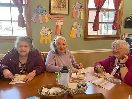 Residents enjoying an activity together in the dining room.