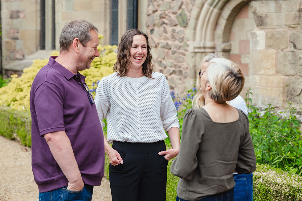 Three fundraising consultants from Orchard Fundraising share a light moment.