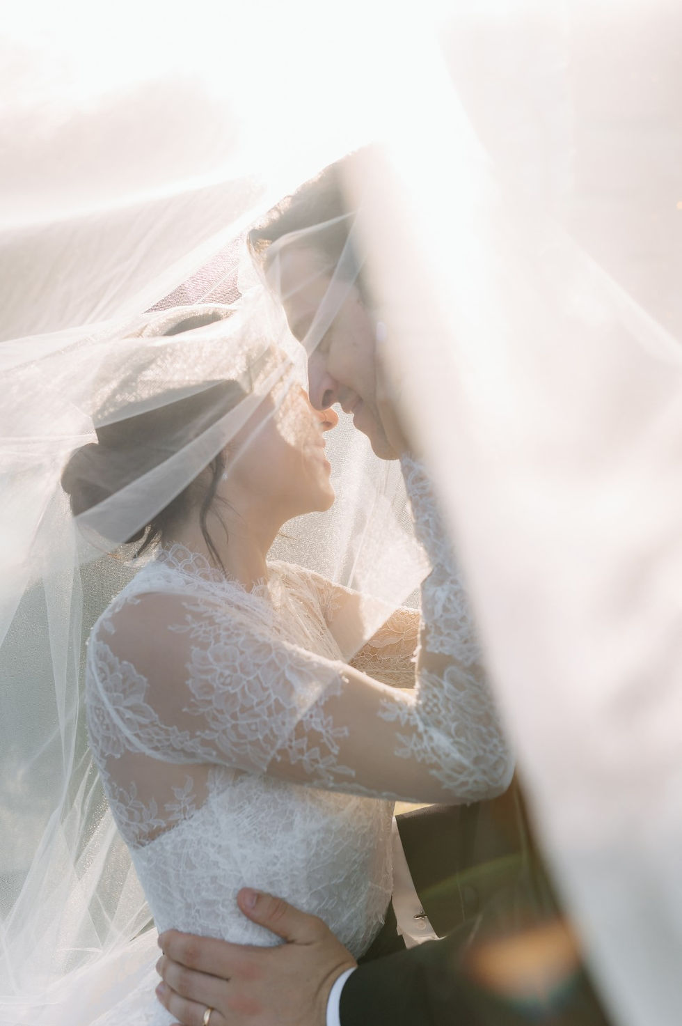 bride and groom under the veil