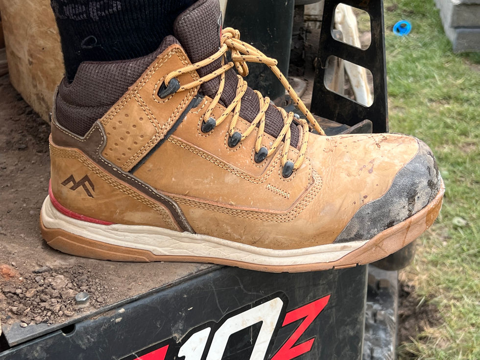 Close-up of a work boot, with lacing and a brown and tan color.