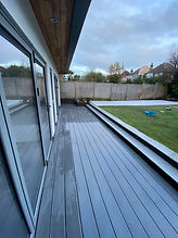 Light Grey Composite Decks with glass doors and a garden view Dk Landscapes Nottin