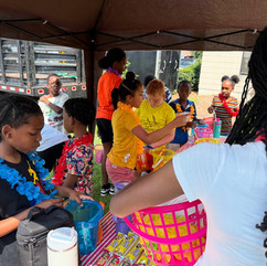 Kids proudly showing off island-themed crafts created at Influx Community Cares Foundation’s day camp in Greenville