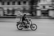 Man on motor cycle delivery.jpeg