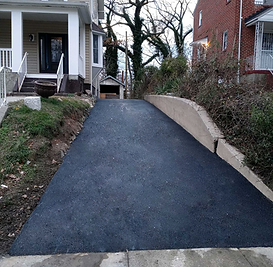 Smooth, black surface providing a sturdy driveway for vehicles.